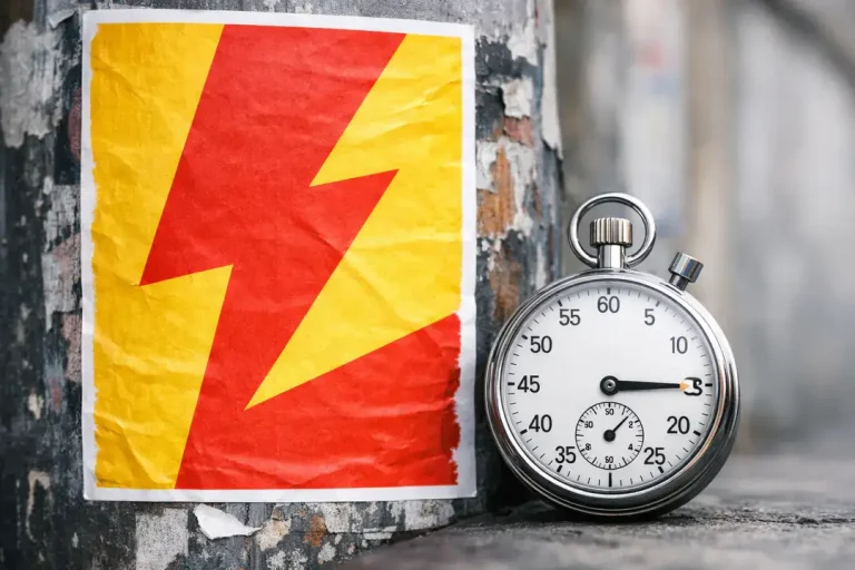 Stopwatch beside lightning bolt poster