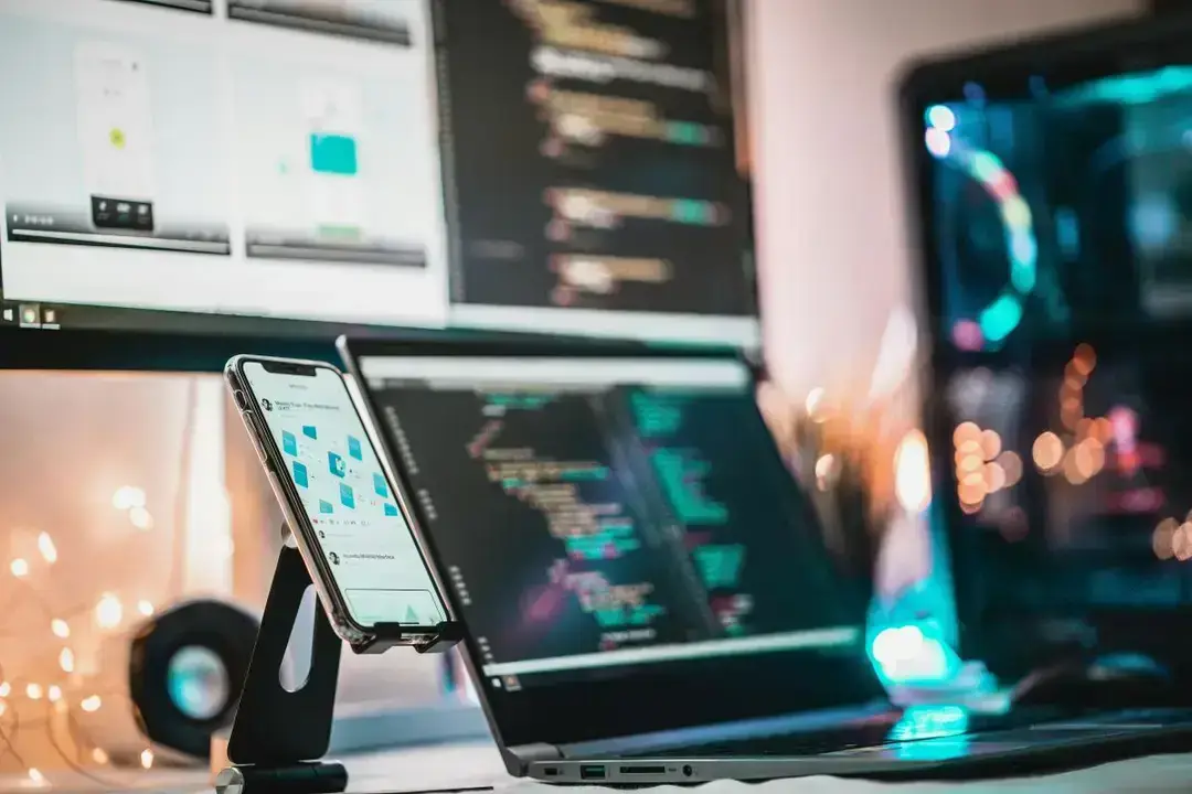 Coding workspace with phone and monitors Coding workspace with phone and monitors