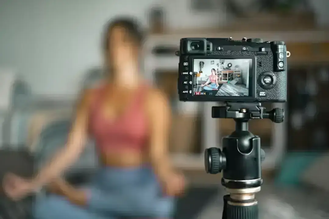 Camera filming woman doing yoga Camera filming woman doing yoga