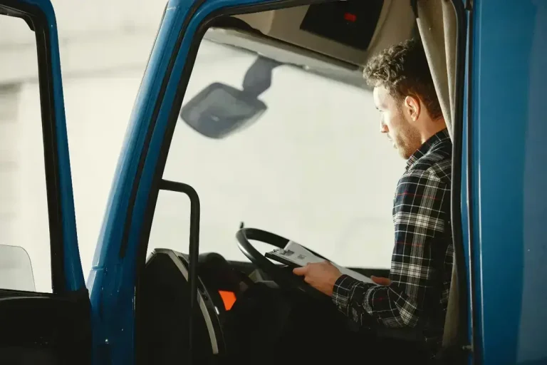 Man in truck cab using tablet