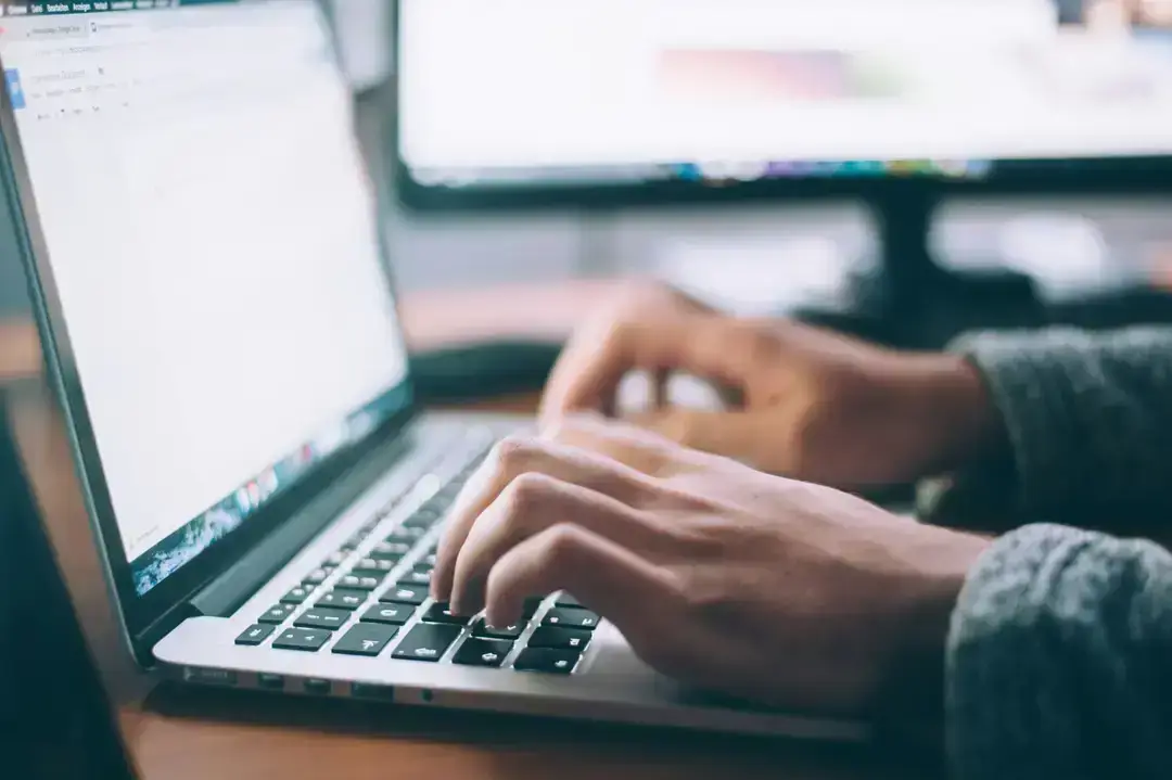 Hands typing on a laptop Hands typing on a laptop