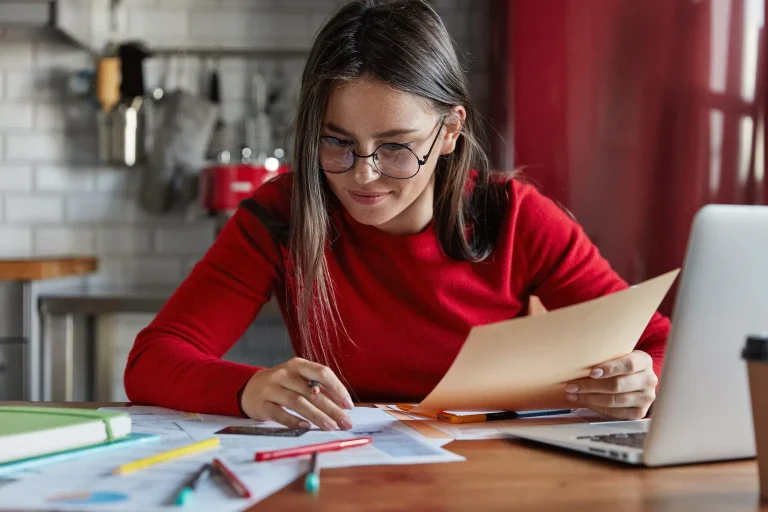 Woman reviewing papers at desk